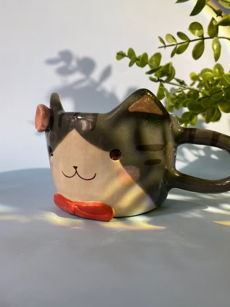 Handmade ceramic cup. Handmade ceramic mug with cute cat and flower lover for gifts.