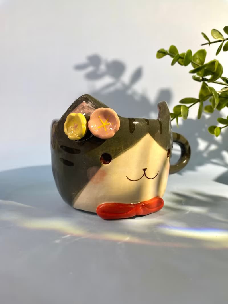 Handmade ceramic cup. Handmade ceramic mug with cute cat and flower lover for gifts.