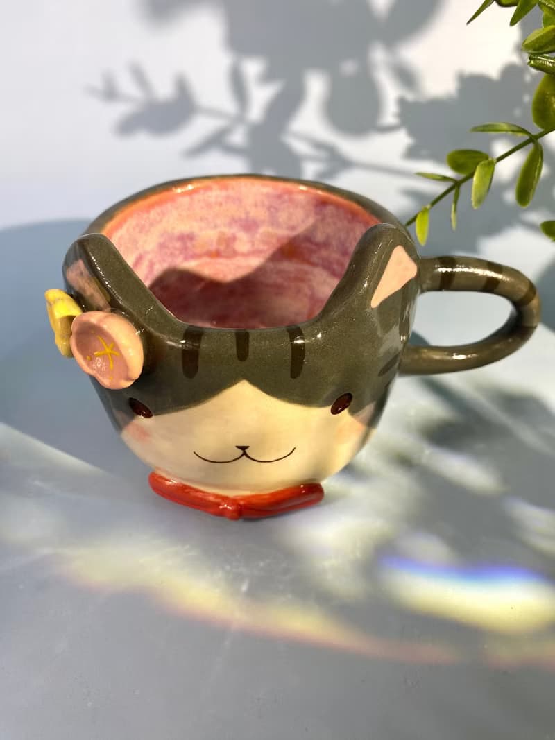 Handmade ceramic cup. Handmade ceramic mug with cute cat and flower lover for gifts.