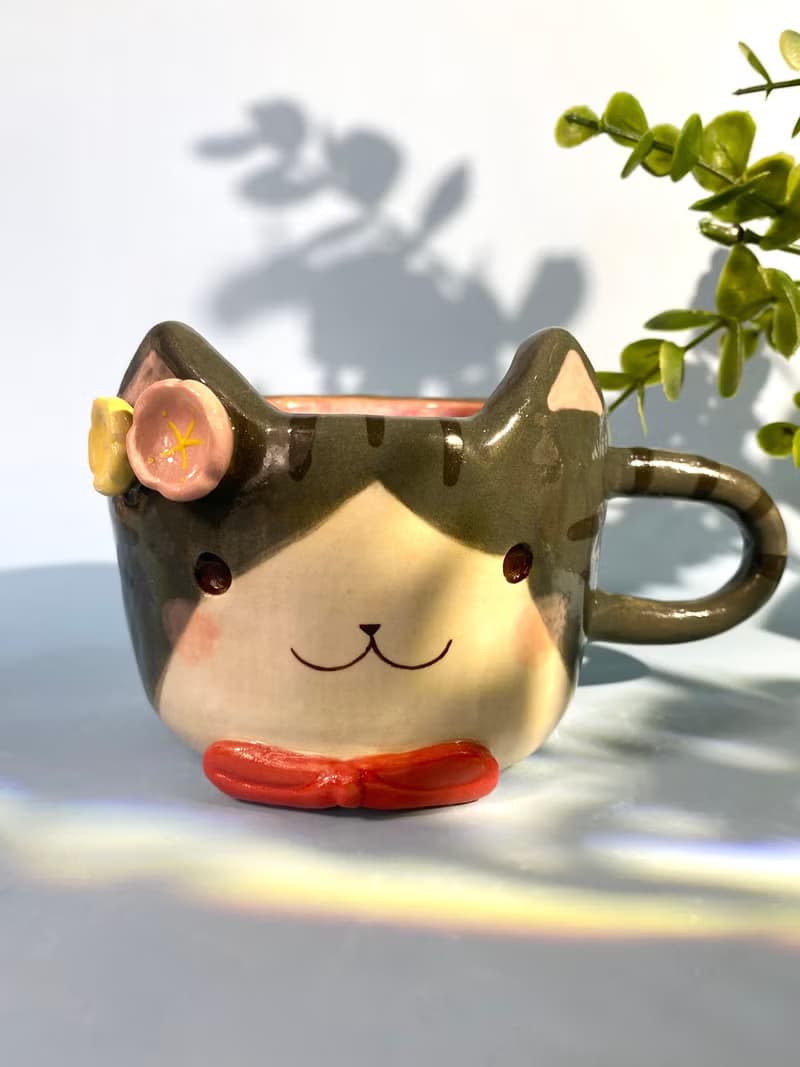 Handmade ceramic cup. Handmade ceramic mug with cute cat and flower lover for gifts.