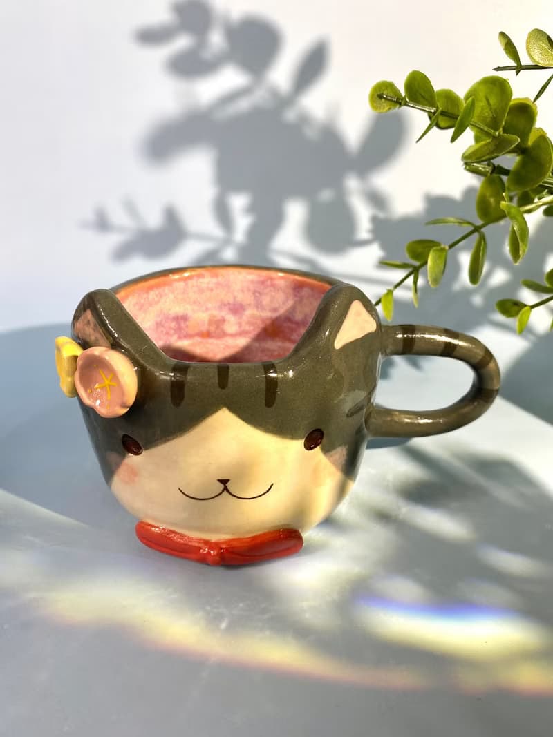 Handmade ceramic cup. Handmade ceramic mug with cute cat and flower lover for gifts.