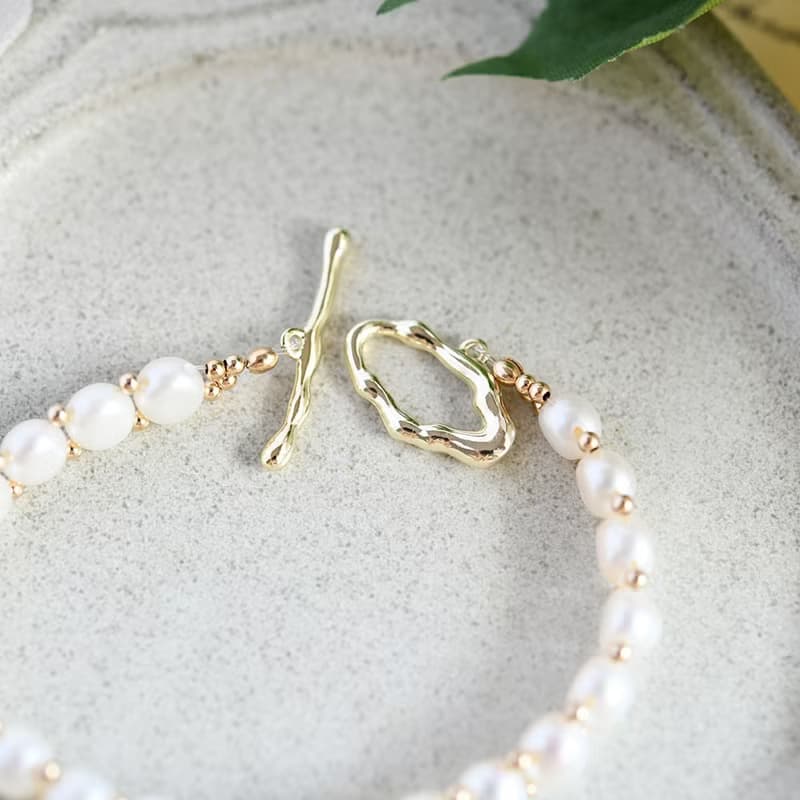 成功へと導いてくれる　キスミー　サンストーンとバロックパールの手編みブレスレット 5月/6月誕生石