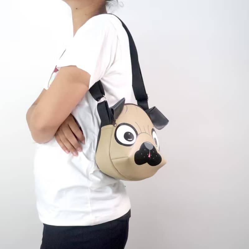 Pug crossbody bag is compact fro carrying mobile phones and other essentials.