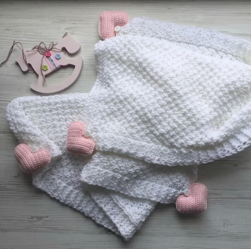 Hand knit white blanket with blue, or pink hearts toys for baby. Baptism blanket