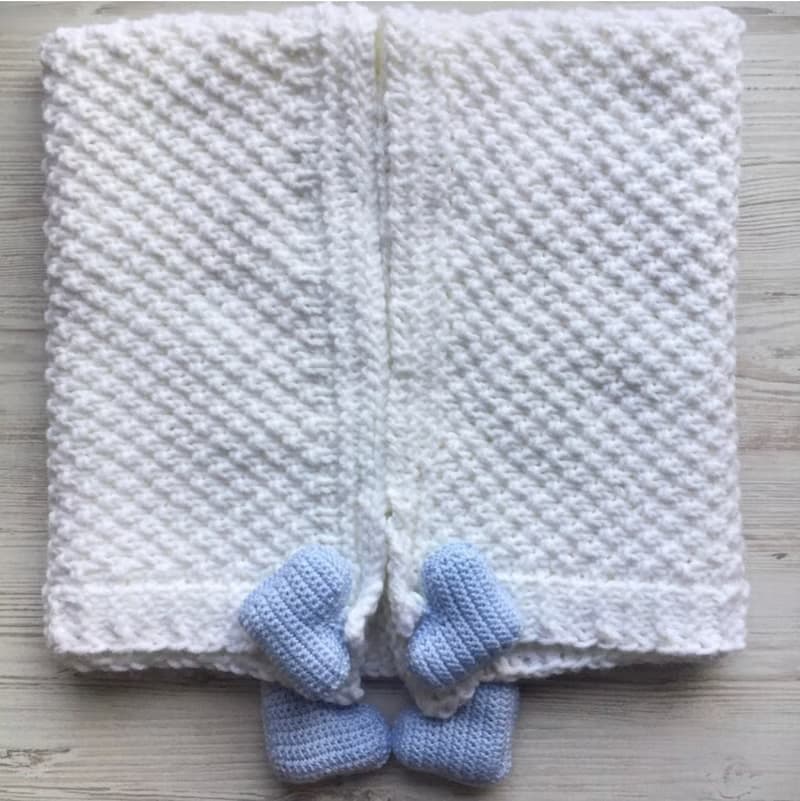 Hand knit white blanket with blue, or pink hearts toys for baby. Baptism blanket