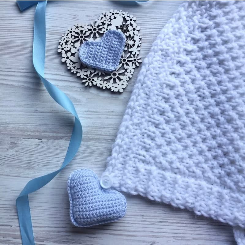 Hand knit white blanket with blue, or pink hearts toys for baby. Baptism blanket