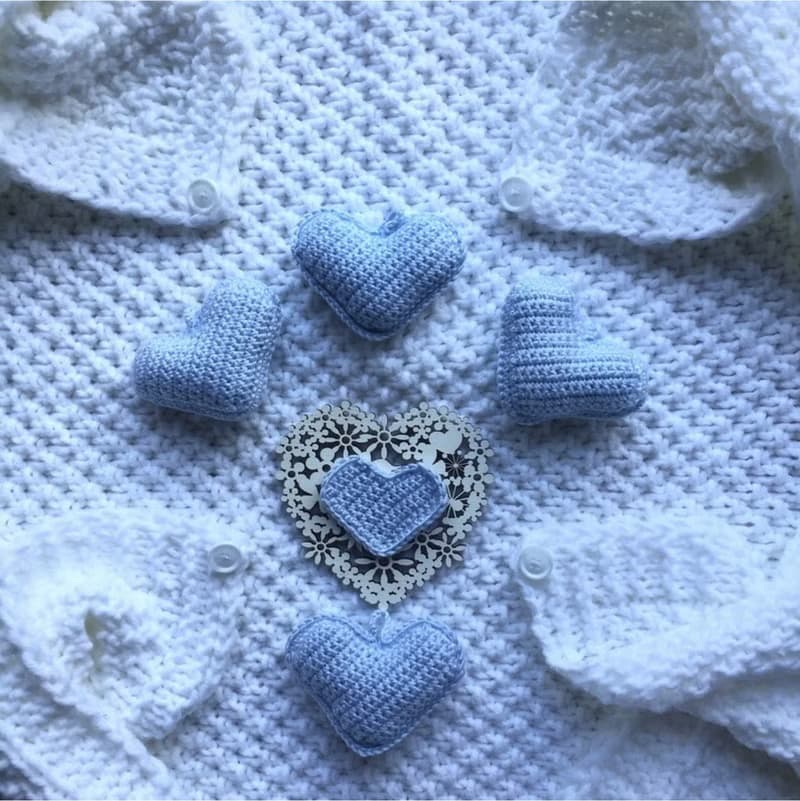 Hand knit white blanket with blue, or pink hearts toys for baby. Baptism blanket