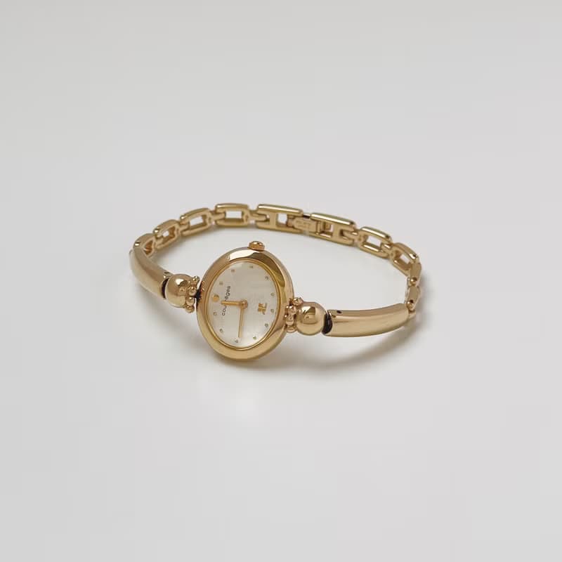 Courreges Gold Tone Bangle Style Bracelet Watch