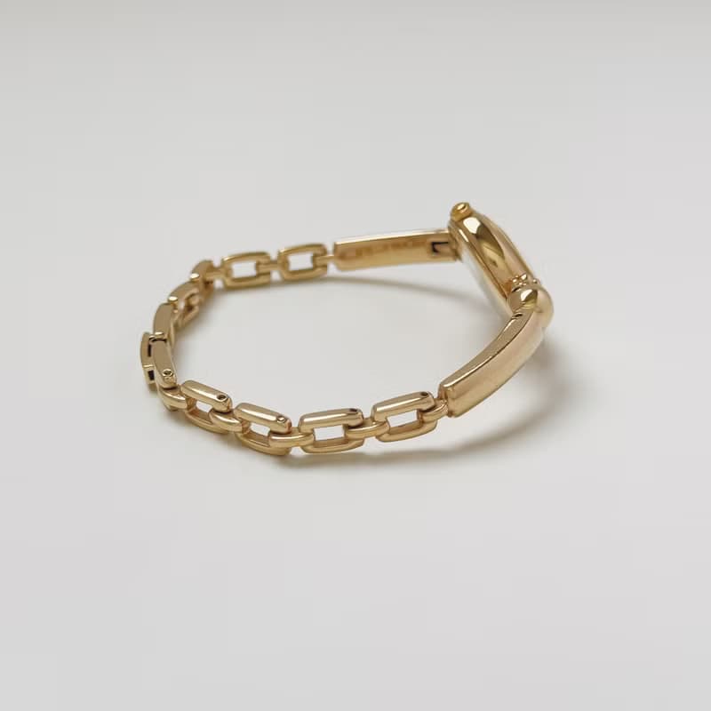 Courreges Gold Tone Bangle Style Bracelet Watch