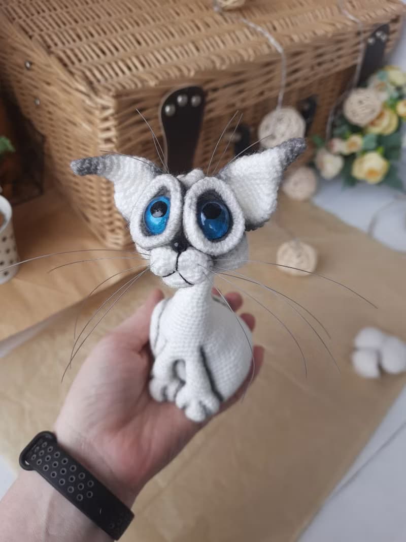 Siamese cat toy sculpture . Knitting sitting realistic pet replica. Cat toy