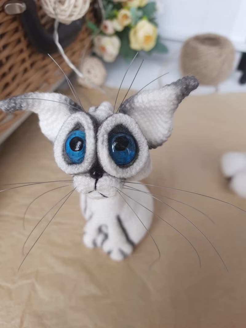 Siamese cat toy sculpture . Knitting sitting realistic pet replica. Cat toy