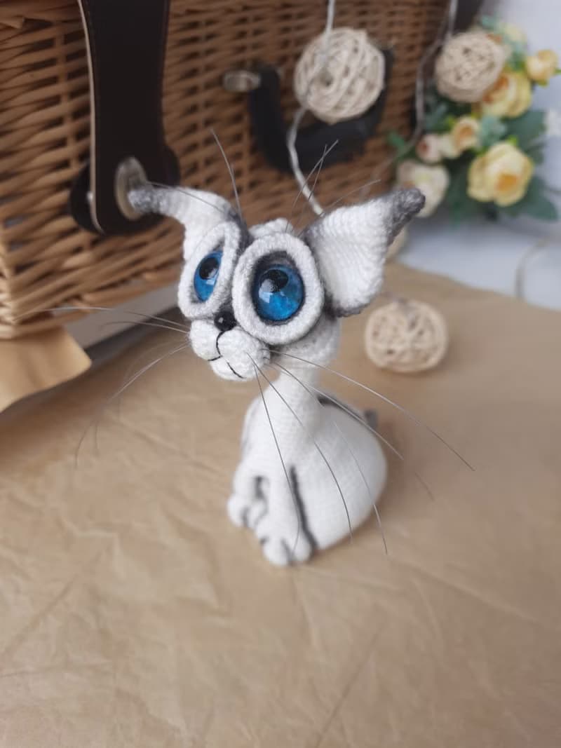 Siamese cat toy sculpture . Knitting sitting realistic pet replica. Cat toy