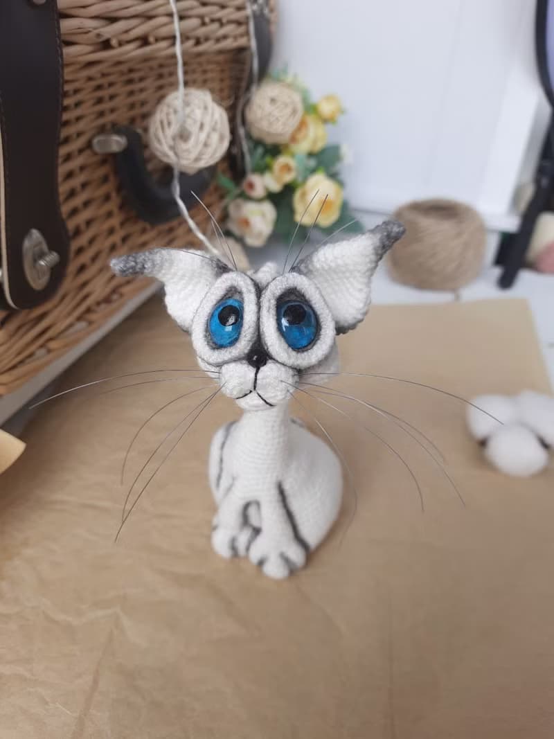 Siamese cat toy sculpture . Knitting sitting realistic pet replica. Cat toy