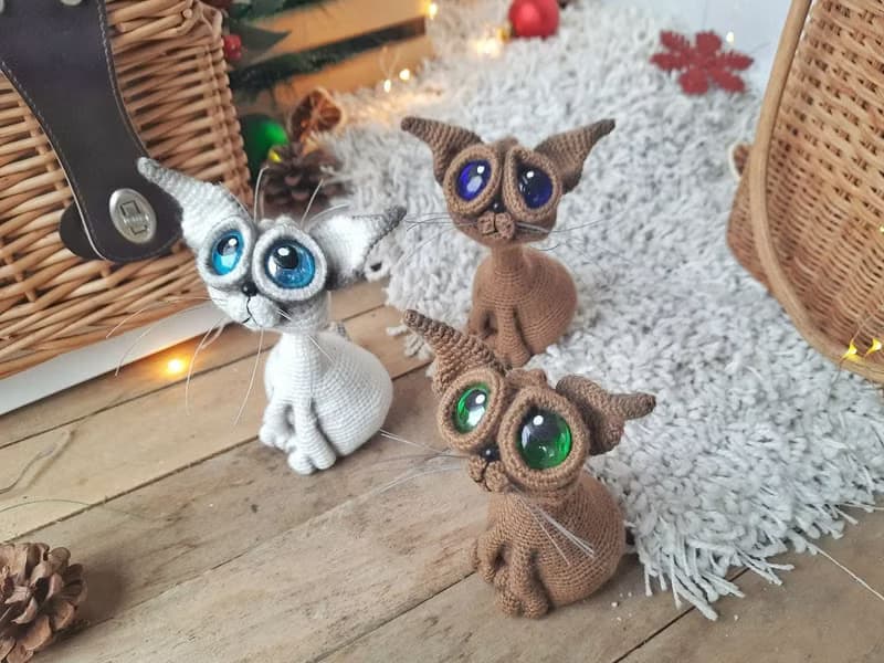 Siamese cat toy sculpture . Knitting sitting realistic pet replica. Cat toy