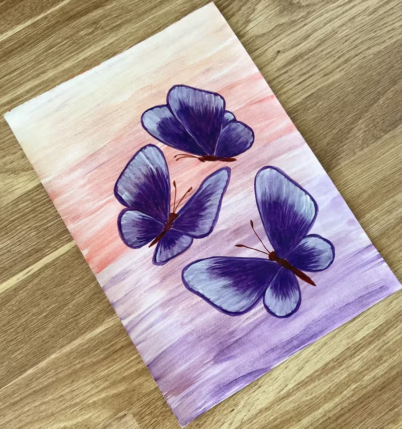 Purple butterflies on a lilac-peach background. Watercolor.