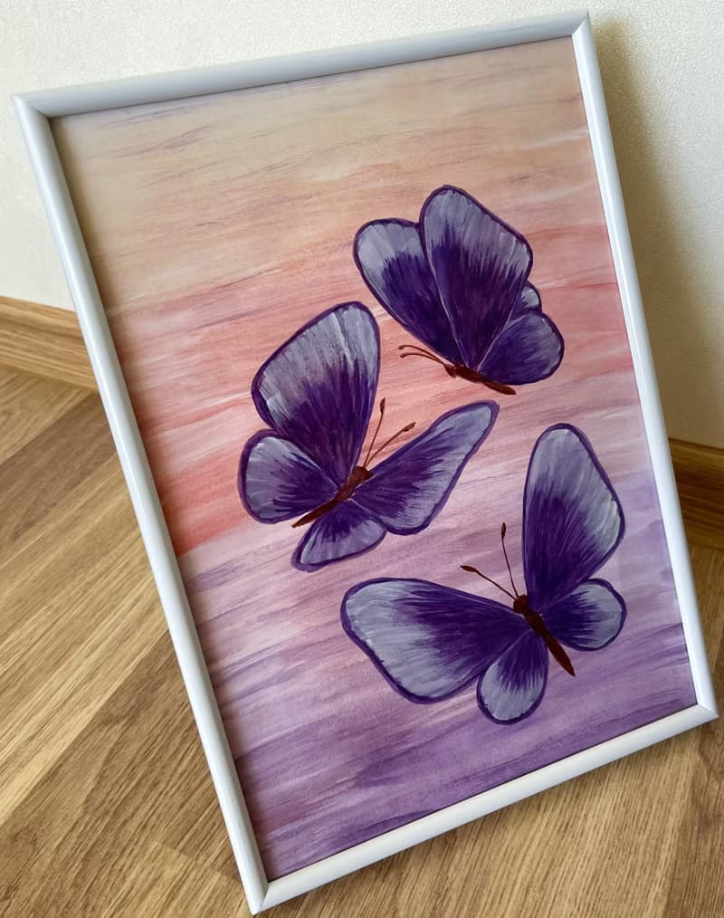Purple butterflies on a lilac-peach background. Watercolor.