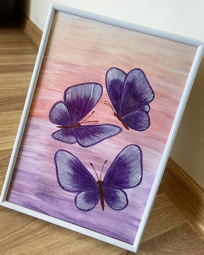 Purple butterflies on a lilac-peach background. Watercolor.