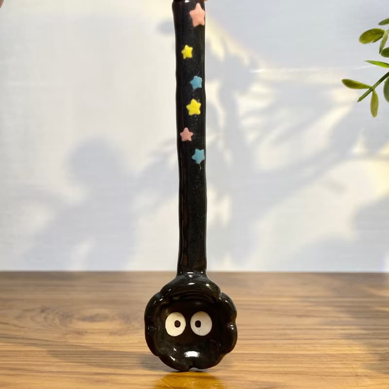 Handmade ceramic spoon with black dust from Totoro.