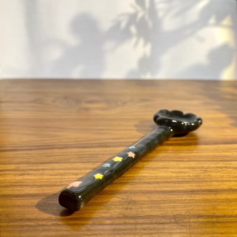 Handmade ceramic spoon with black dust from Totoro.