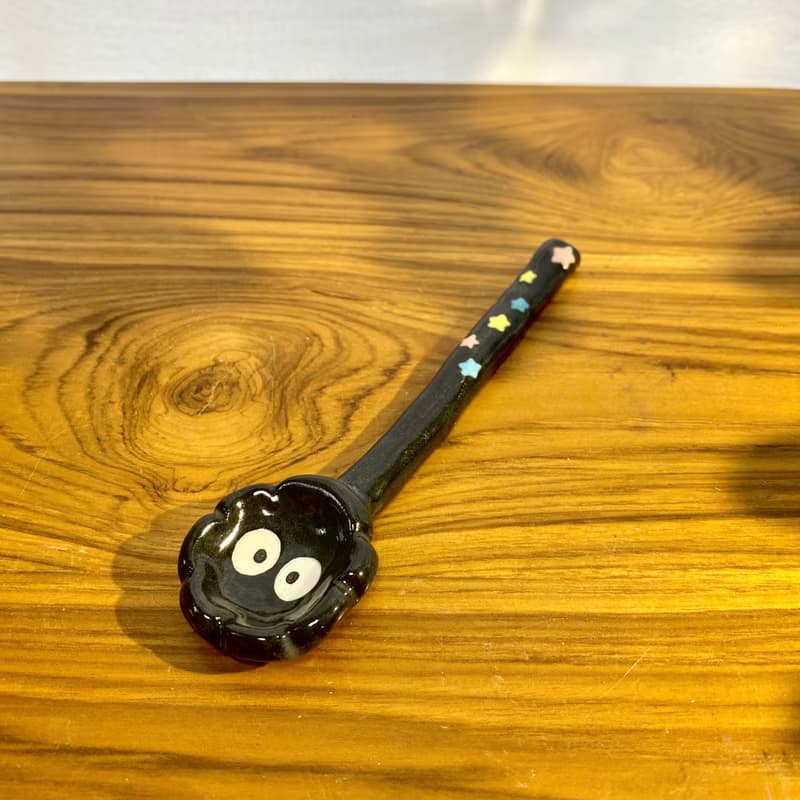 Handmade ceramic spoon with black dust from Totoro.