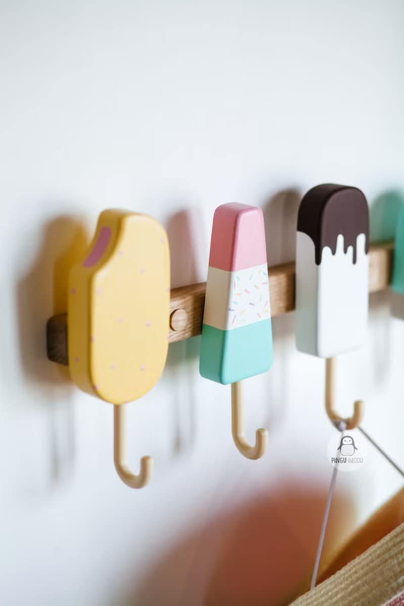 Clothes and towel hanger for nursery with wooden ice cream hooks