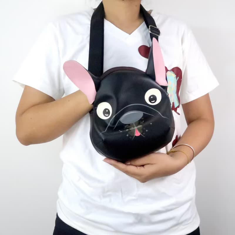 Black french bulldog crossbody bag is compact fro carrying mobile phones.