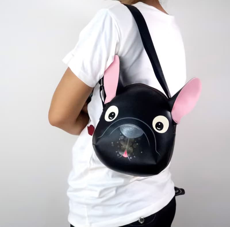Black french bulldog crossbody bag is compact fro carrying mobile phones.