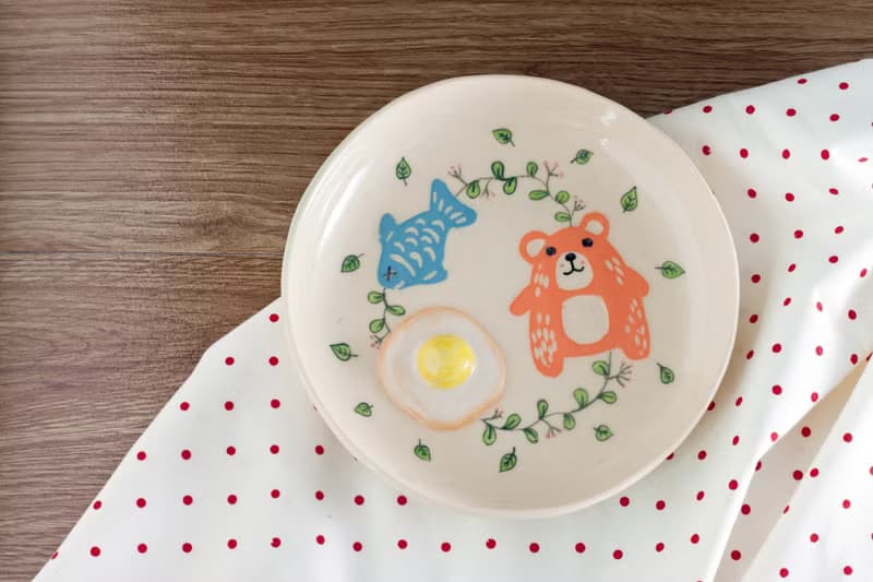 Plate with bear, egg, fish pattern