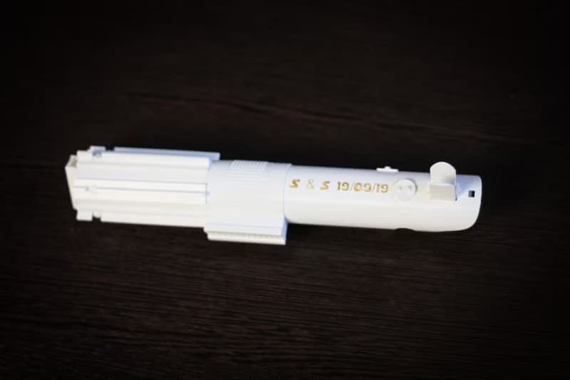 White wedding bouquet holder inspired by Luke's lightsaber hilt