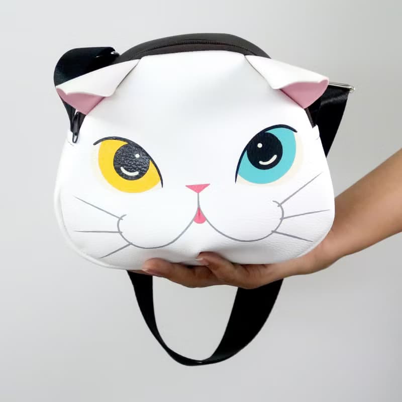 White cat crossbody bag is compact fro carrying mobile phones.