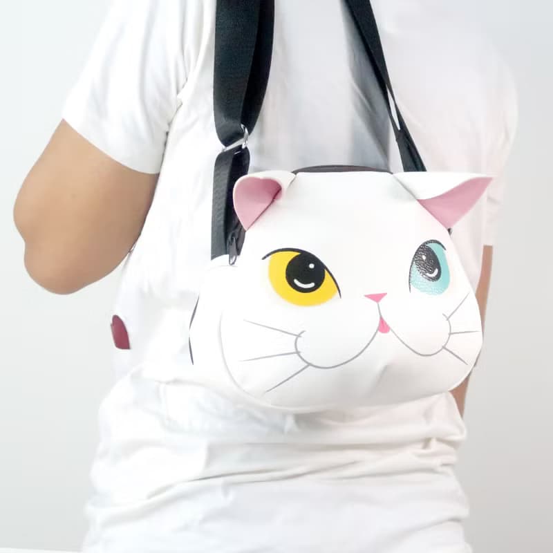 White cat crossbody bag is compact fro carrying mobile phones.