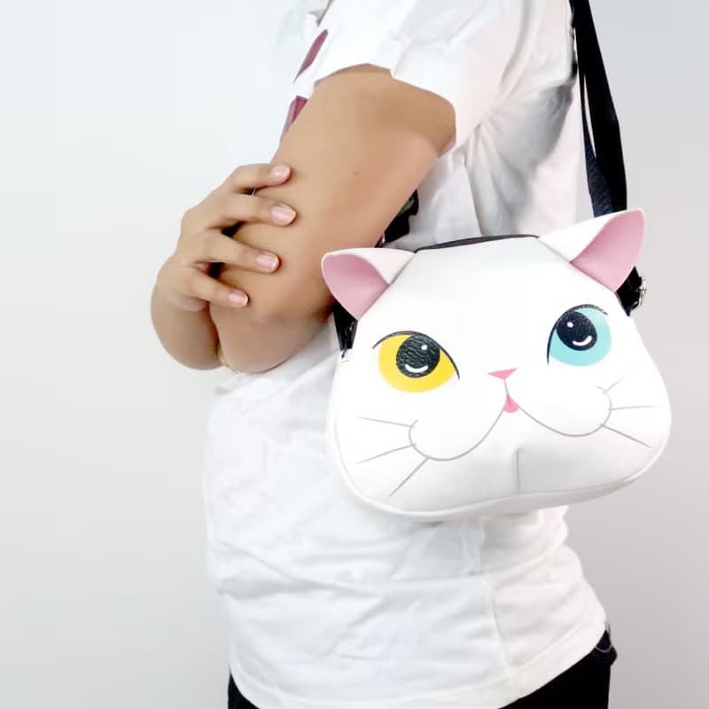 White cat crossbody bag is compact fro carrying mobile phones.
