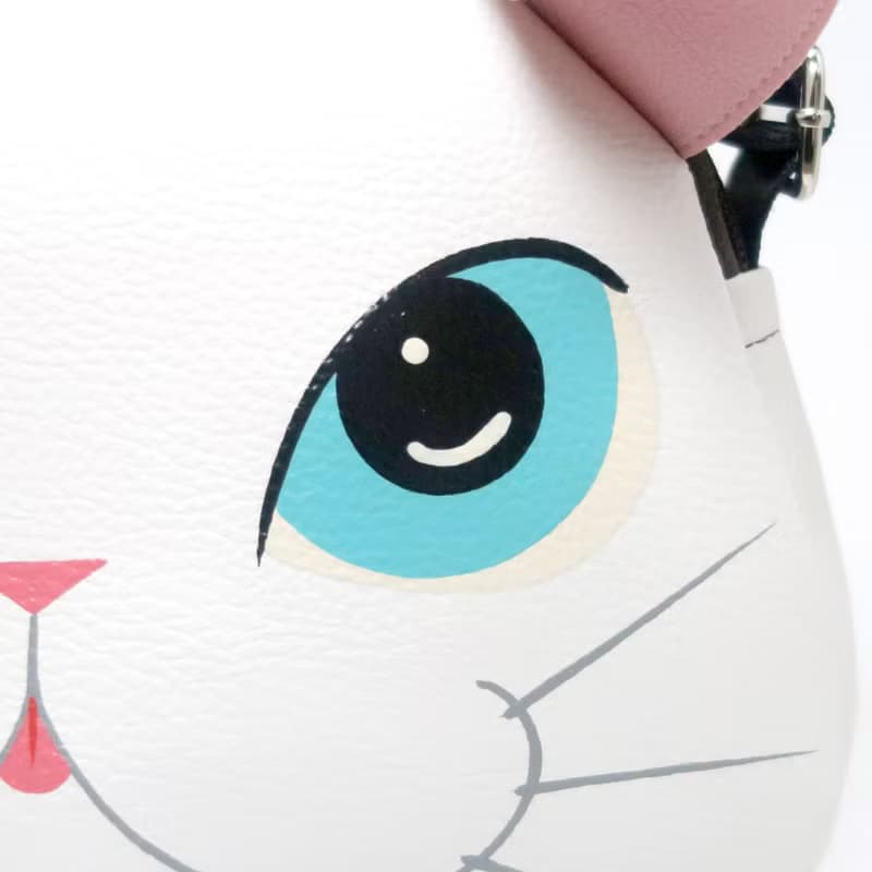 White cat crossbody bag is compact fro carrying mobile phones.