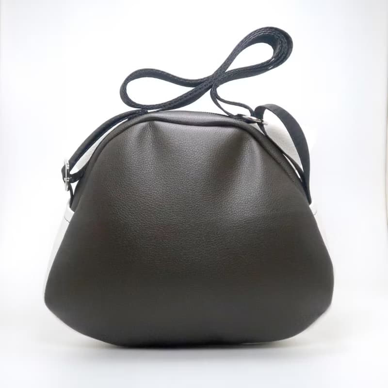 White cat crossbody bag is compact fro carrying mobile phones.