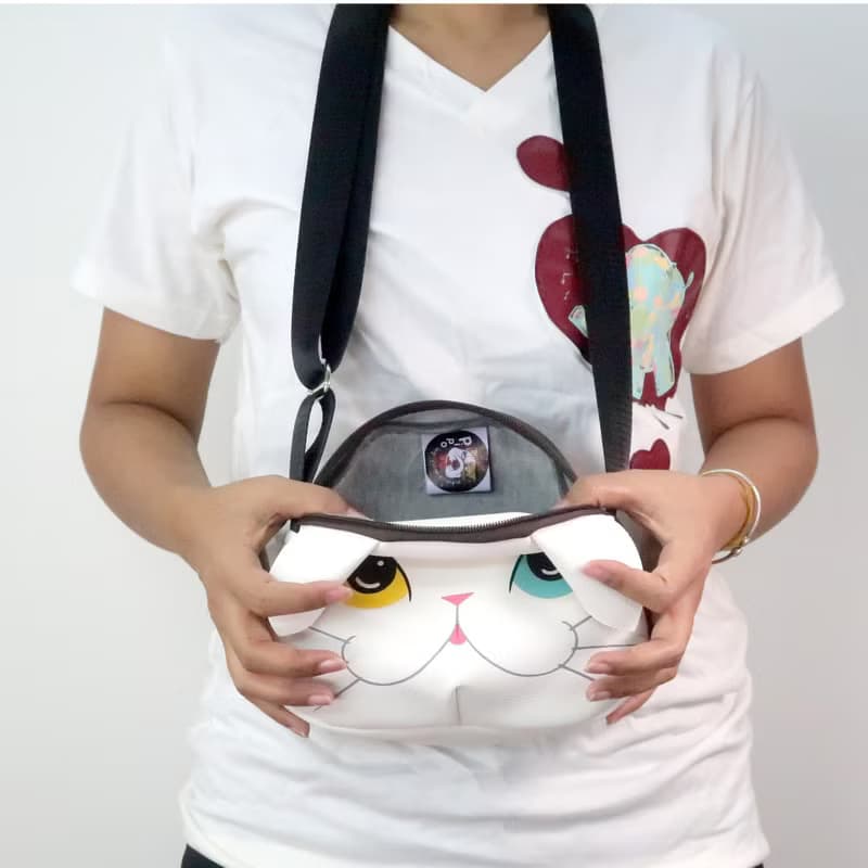 White cat crossbody bag is compact fro carrying mobile phones.