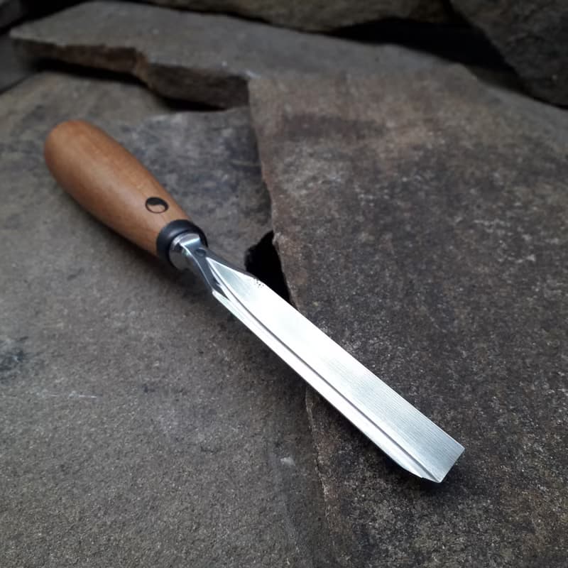 Forged  V-chisel. Woodworking tool. Woodcarving chisel.
