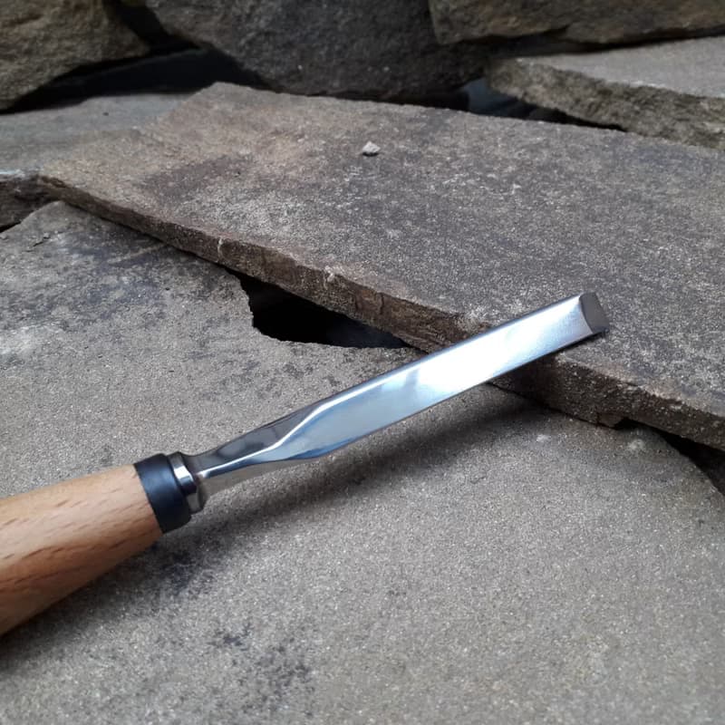 Forged  V-chisel. Woodworking tool. Woodcarving chisel.