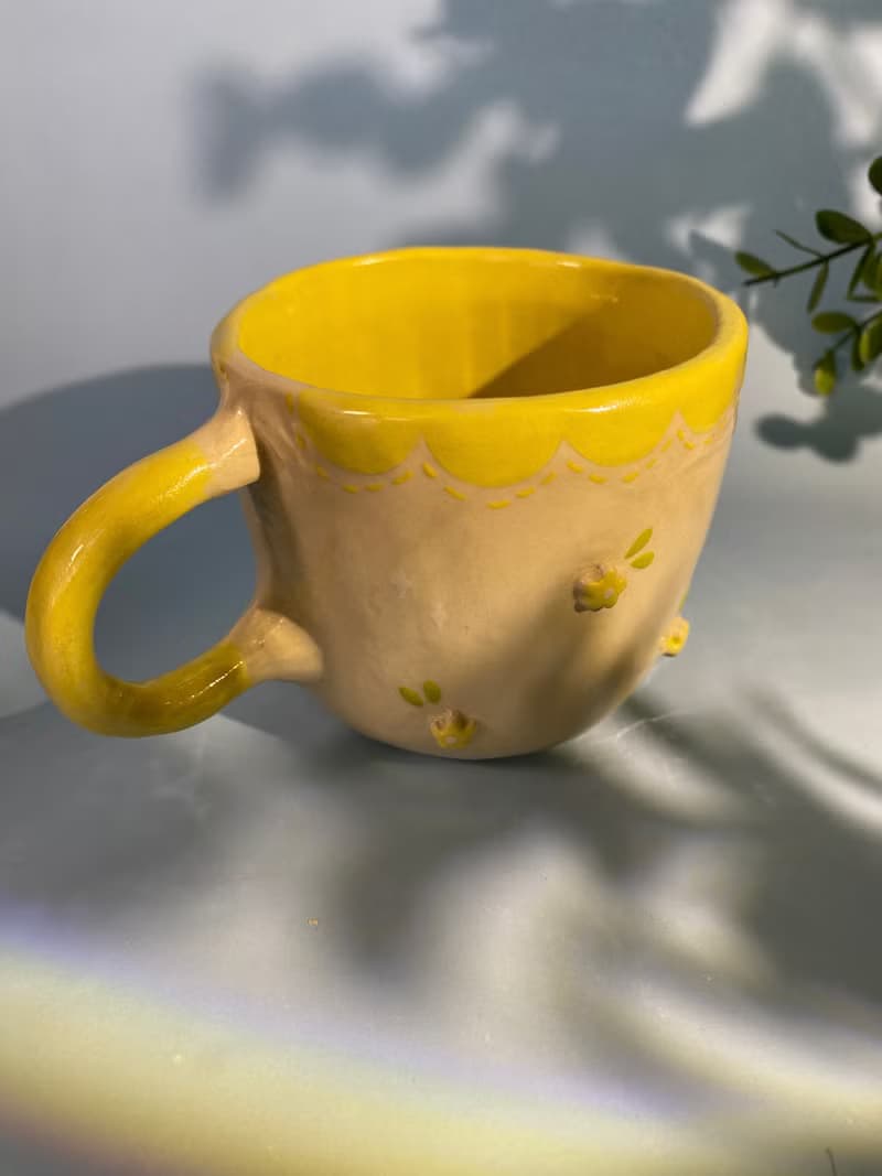 Handmade ceramic cup. Handmade ceramic mug with cute flower lover pattern for gifts.