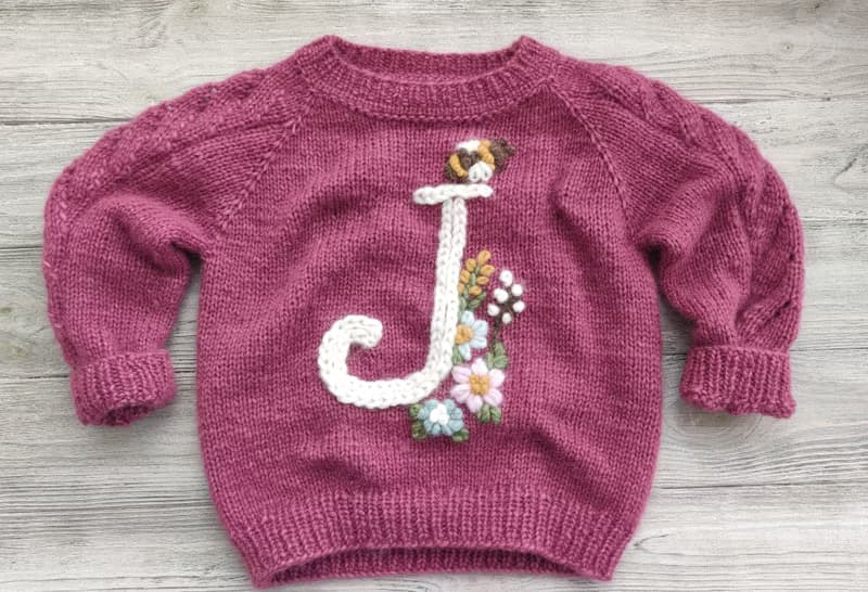Handmade alpaca sweater with baby's name and embroidered flowers. Gift for girl.