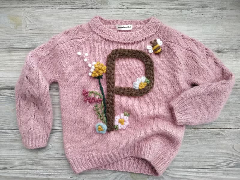 Handmade alpaca sweater with baby's name and embroidered flowers. Gift for girl.