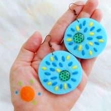 Colorful free-form dangle earring design with hand-stitching on felt with beads