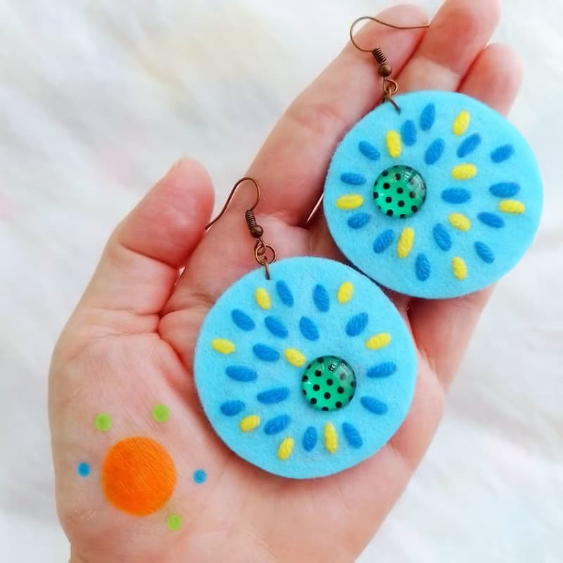 Colorful free-form dangle earring design with hand-stitching on felt with beads