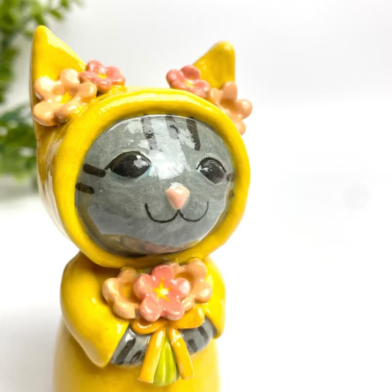 Handmade ceramic doll vase with a cute yellow cat and flower lover.
