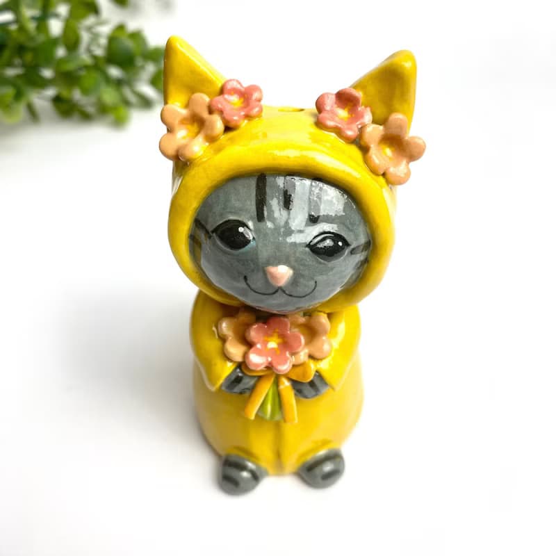 Handmade ceramic doll vase with a cute yellow cat and flower lover.