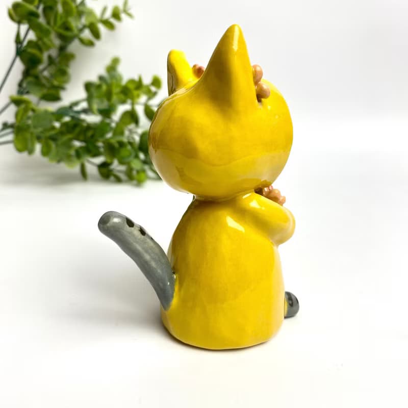 Handmade ceramic doll vase with a cute yellow cat and flower lover.