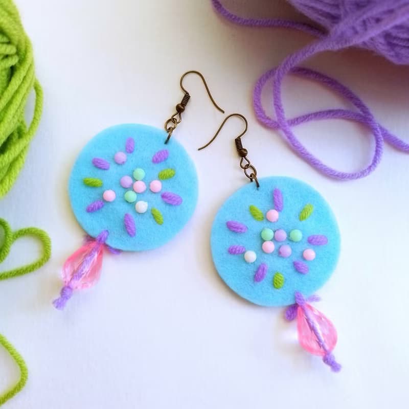 Cute free-form dangle earrings design with hand-stitching on hard felt, beads