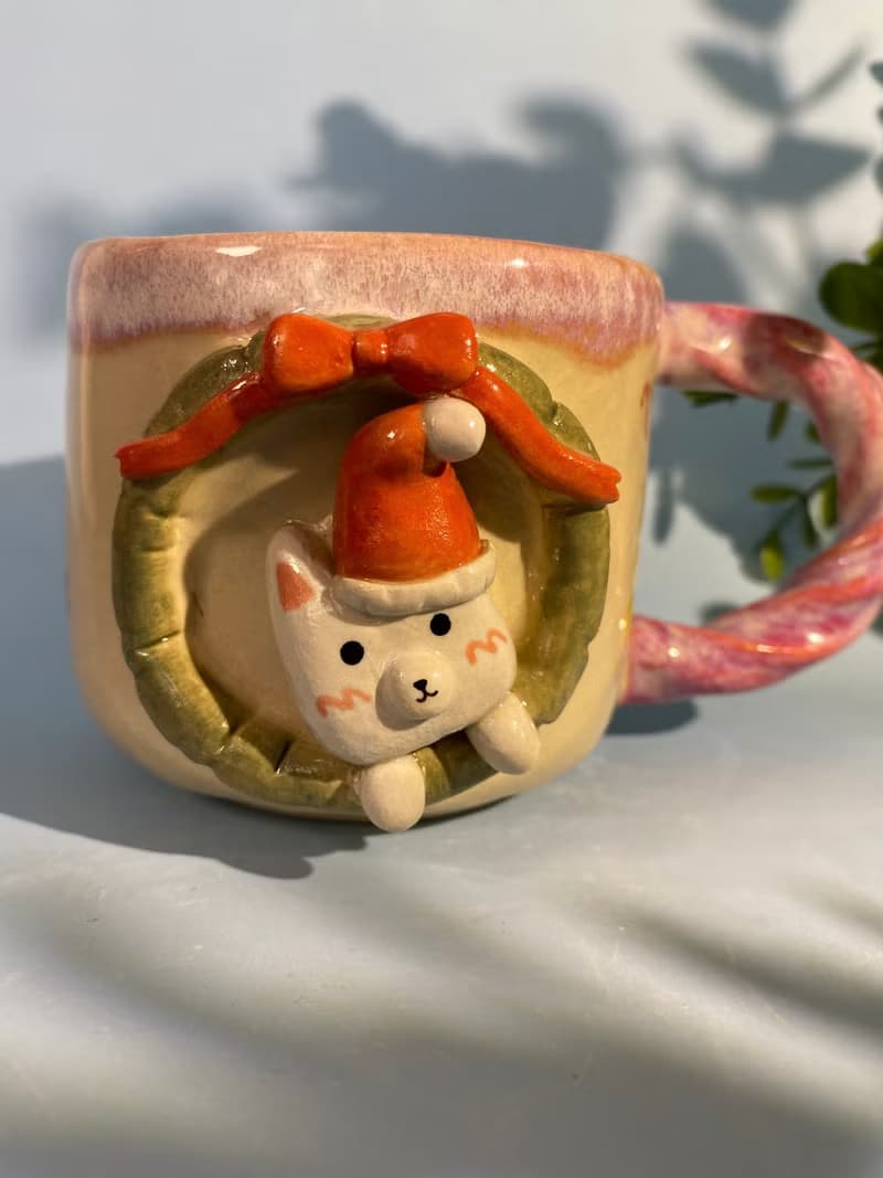 Handmade ceramic cup. Handmade ceramic mug with cute Santa cat pattern. for gifts