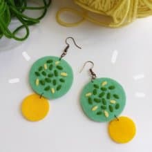 Colorful free-form dangle design with hand-stitching on felt