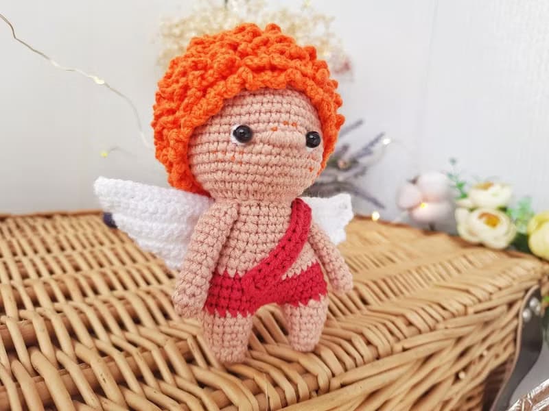 Little angel with red hair gift to parents on the birth of baby. Valentine's Day