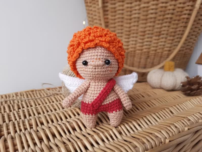 Little angel with red hair gift to parents on the birth of baby. Valentine's Day